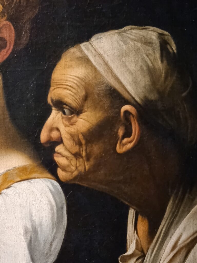 Caravaggio: dettaglio Giuditta che decapita Oloferne